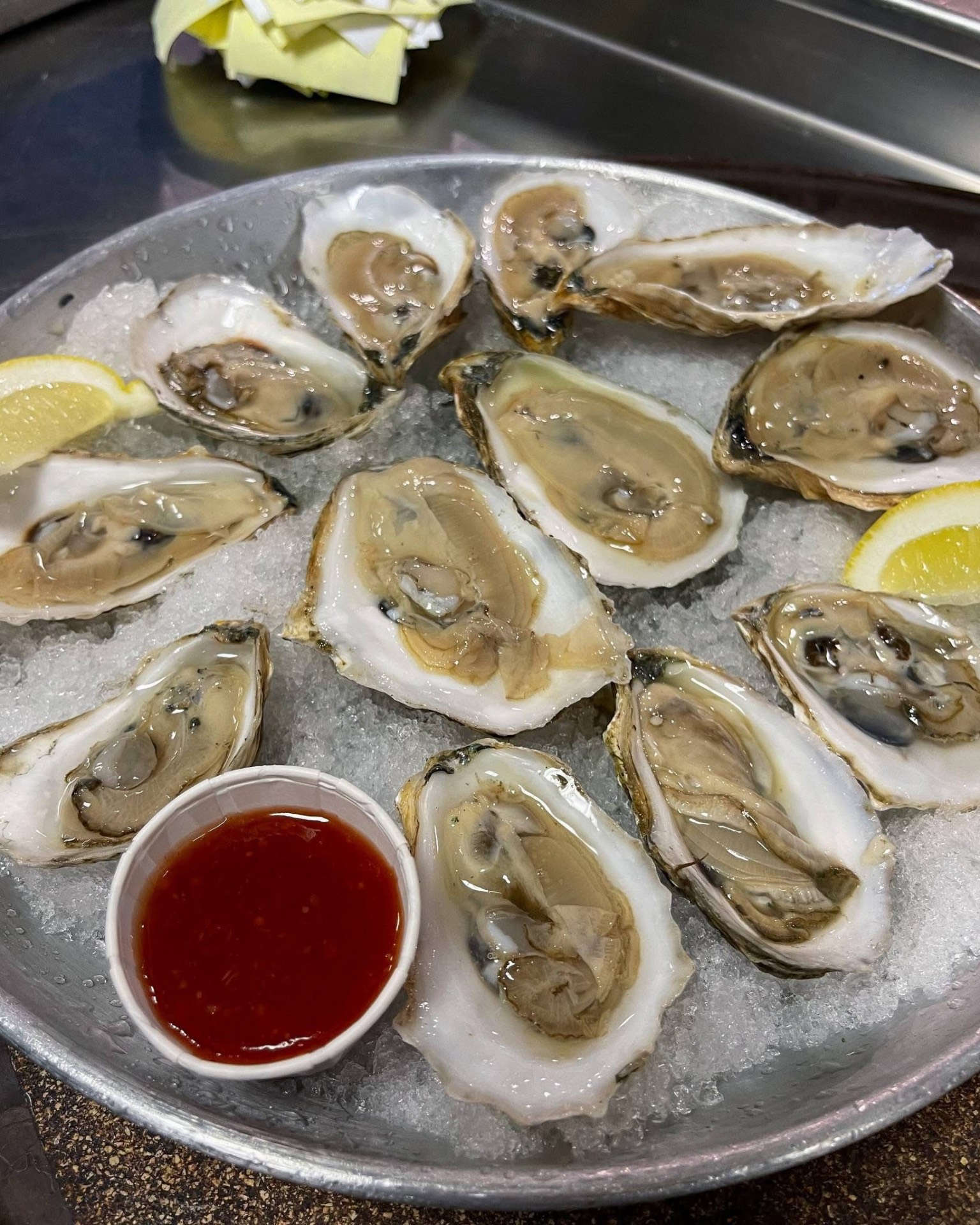 Fresh Maine oysters on the half shell with cocktail sauce and lemon
